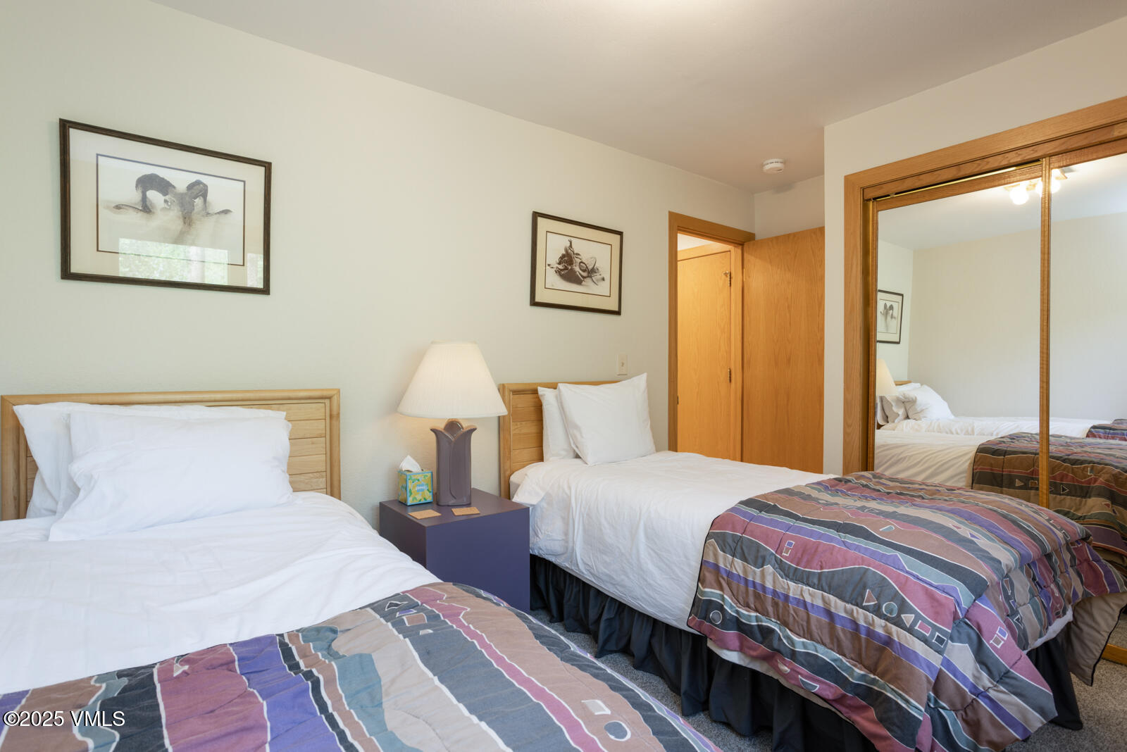 5159 Gore Circle Vail, CO 81657 - Photo 28 of 62 a bedroom with a bed and a lamp on dresser