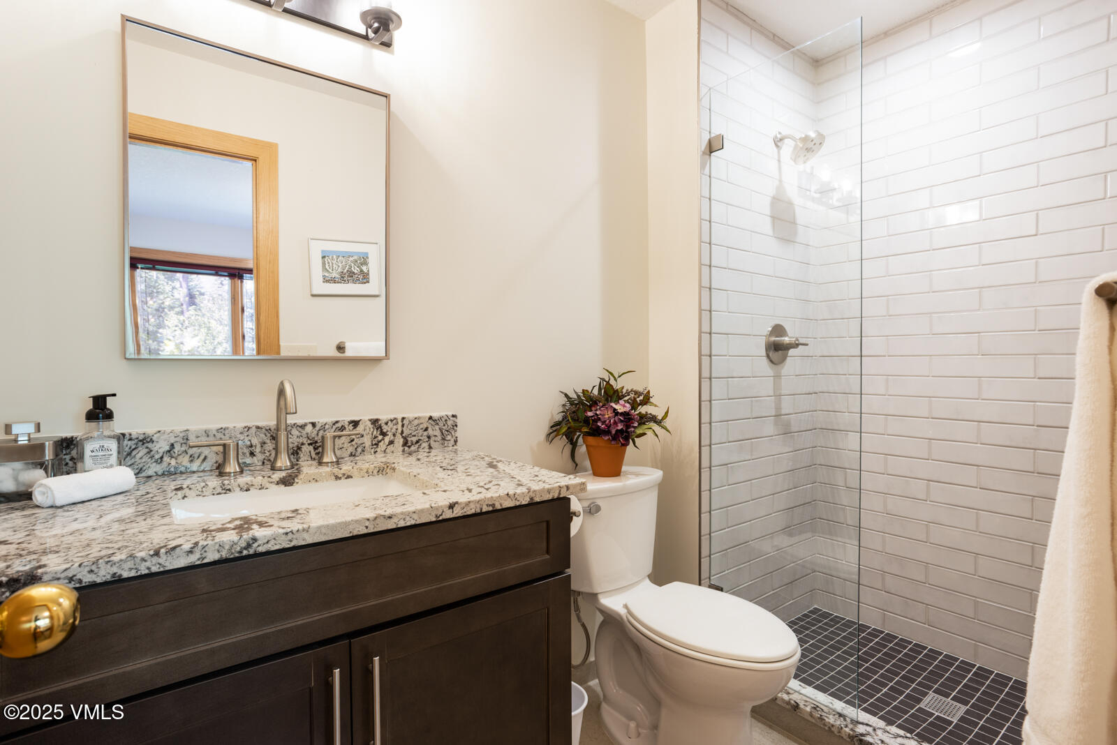 5159 Gore Circle Vail, CO 81657 - Photo 45 of 62 a bathroom with a granite countertop toilet sink and a mirror