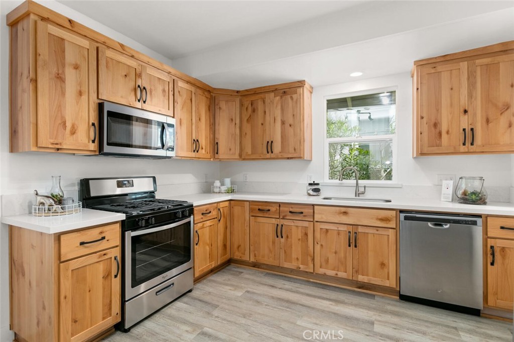 937 Chestnut Street Chico, CA 95928 - Photo 2 of 55 a kitchen with stainless steel appliances granite countertop wooden cabinets stove top oven and sink