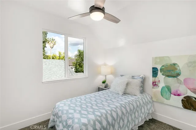 a bedroom with a bed and a lamp