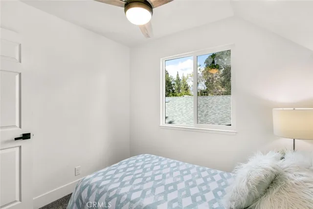 a bedroom with a bed and a lamp