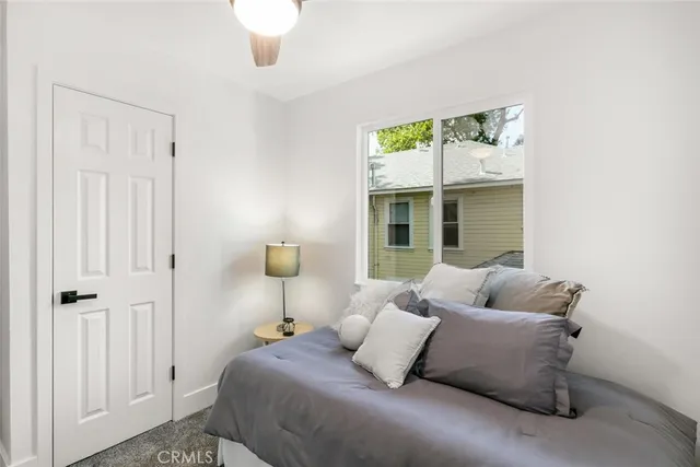 a bedroom with a bed and a painting on the wall