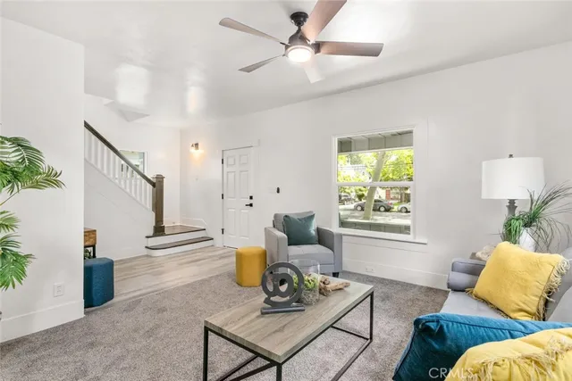 a living room with furniture and a potted plant