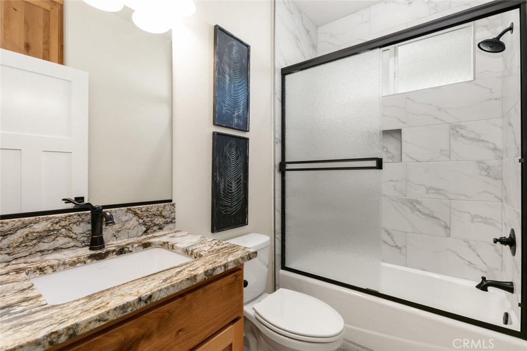 937 Chestnut Street Chico, CA 95928 - Photo 47 of 55 a bathroom with a granite countertop sink toilet and shower