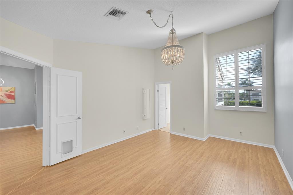 5307 Buckhead Circle, Unit 203 Boca Raton, FL 33431 - Photo 18 of 34 wooden floor in an empty room with a window