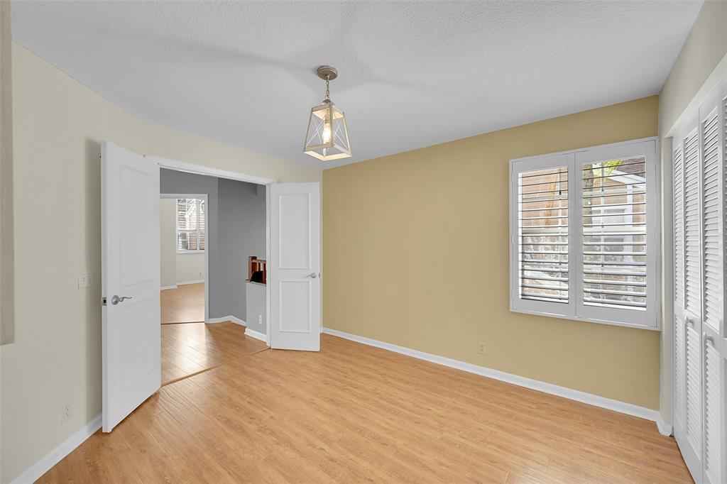 5307 Buckhead Circle, Unit 203 Boca Raton, FL 33431 - Photo 21 of 34 a view of an empty room with wooden floor and a window