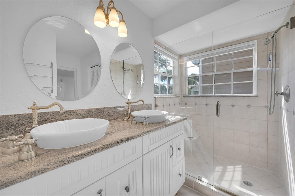 5307 Buckhead Circle, Unit 203 Boca Raton, FL 33431 - Photo 23 of 34 a bathroom with double vanity sinks and a mirror