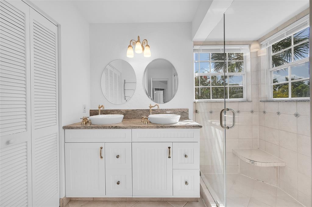 5307 Buckhead Circle, Unit 203 Boca Raton, FL 33431 - Photo 24 of 34 a bathroom with a double vanity sink and a mirror