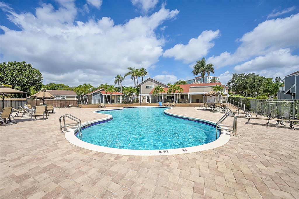 5307 Buckhead Circle, Unit 203 Boca Raton, FL 33431 - Photo 32 of 34 a view of a swimming pool with an outdoor seating