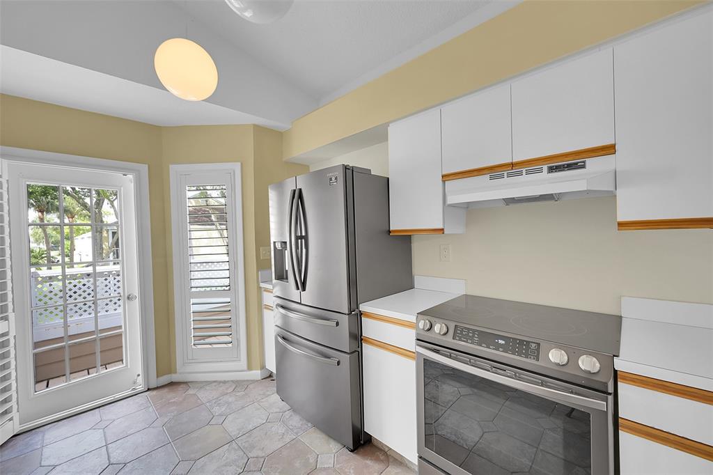 5307 Buckhead Circle, Unit 203 Boca Raton, FL 33431 - Photo 7 of 34 a kitchen with a stove and a refrigerator