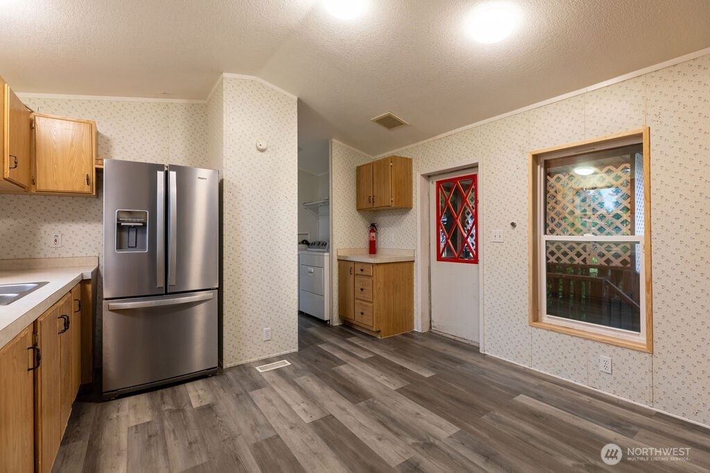 230 Misty Circle Forks, WA 98331 - Photo 18 of 33 a kitchen with stainless steel appliances granite countertop a refrigerator and a stove top oven