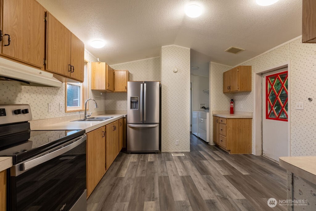 230 Misty Circle Forks, WA 98331 - Photo 19 of 33 a kitchen with a refrigerator and a stove top oven
