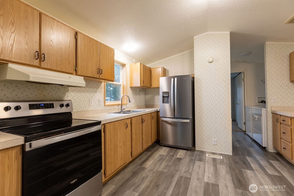 230 Misty Circle Forks, WA 98331 - Photo 28 of 33 a kitchen with a refrigerator stove and sink