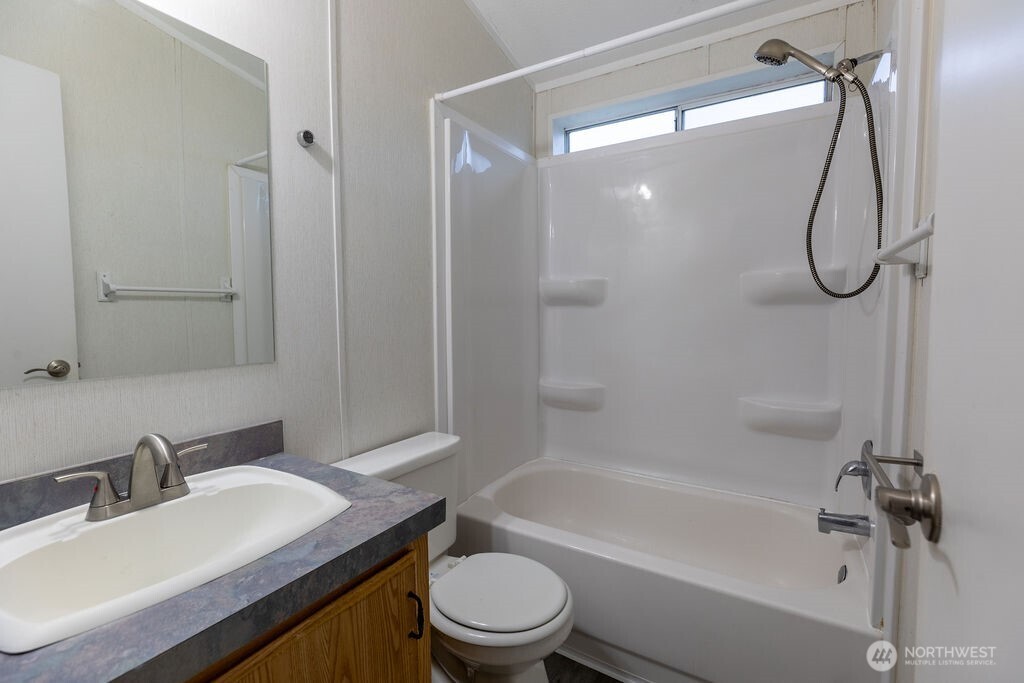 230 Misty Circle Forks, WA 98331 - Photo 8 of 33 a bathroom with a sink a toilet and a mirror