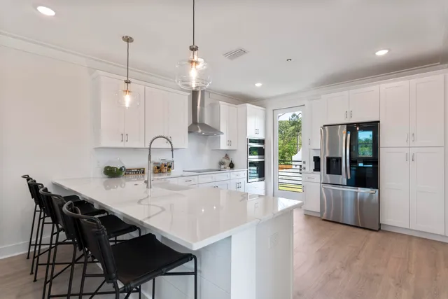 a kitchen with stainless steel appliances a refrigerator sink and cabinets