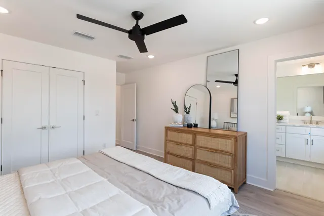 a bathroom with a double vanity sink toilet mirror and view