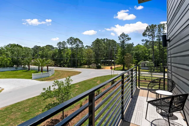a view of a balcony with two chairs and a potted plant