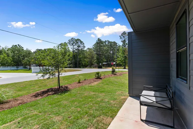 a view of a house with backyard and porch