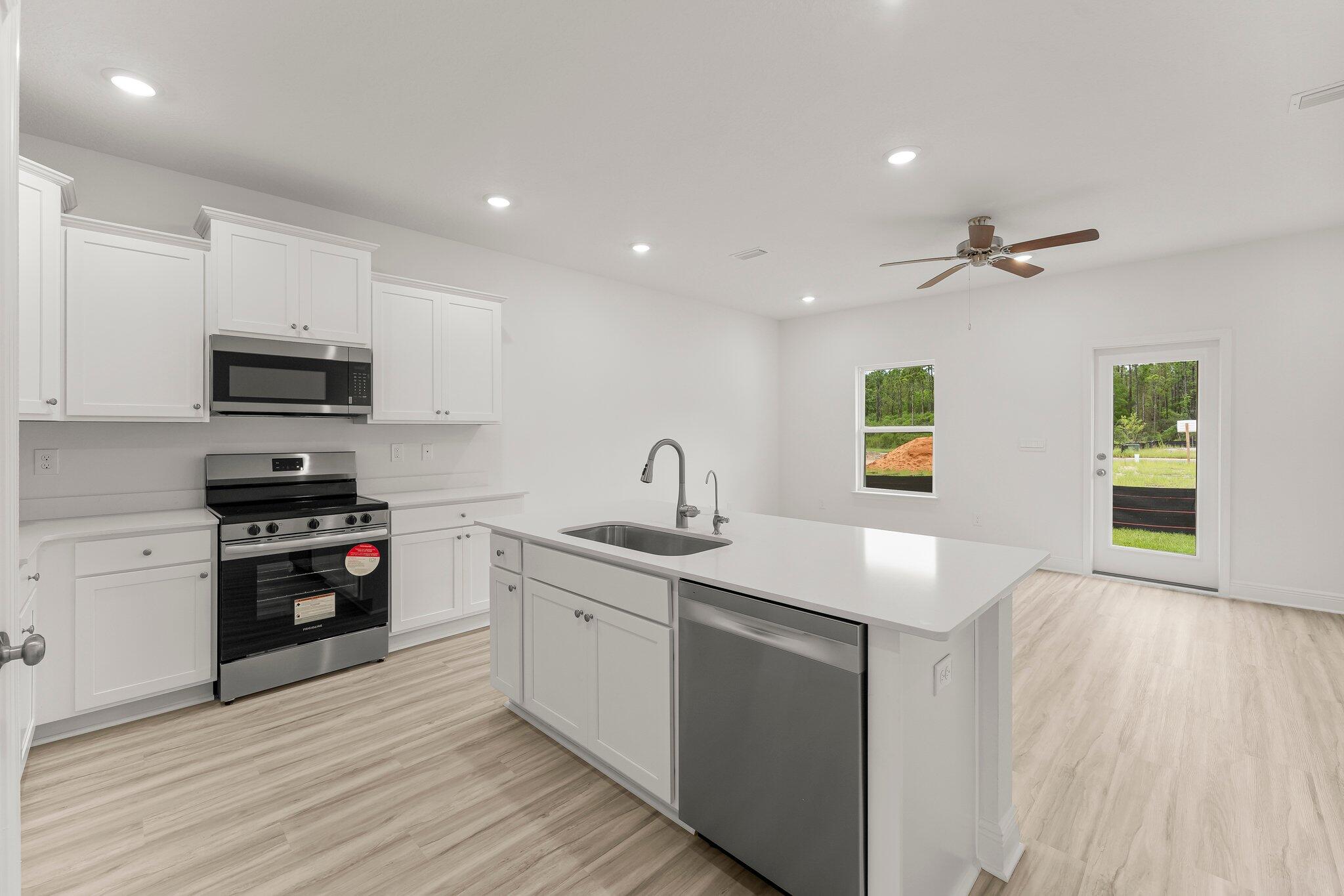 18 Hawk Street Santa Rosa Beach, FL 32459 - Photo 11 of 34 a kitchen with stainless steel appliances granite countertop a sink and a stove top oven