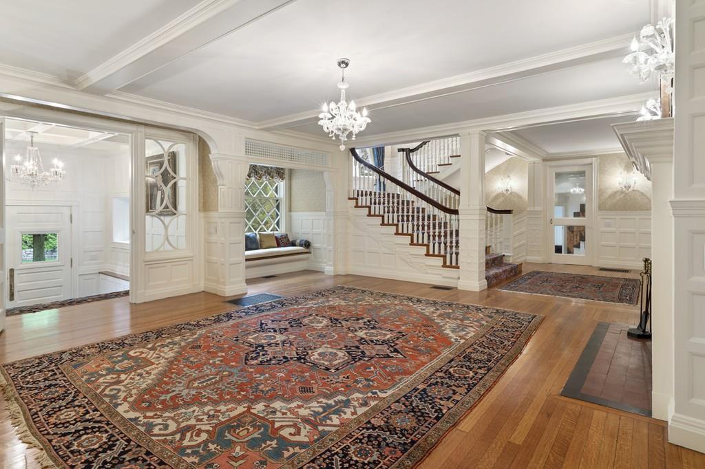 30 Warren Street Brookline, MA 02445 - Photo 11 of 27 an entryway with a rug wooden floor and a chandelier