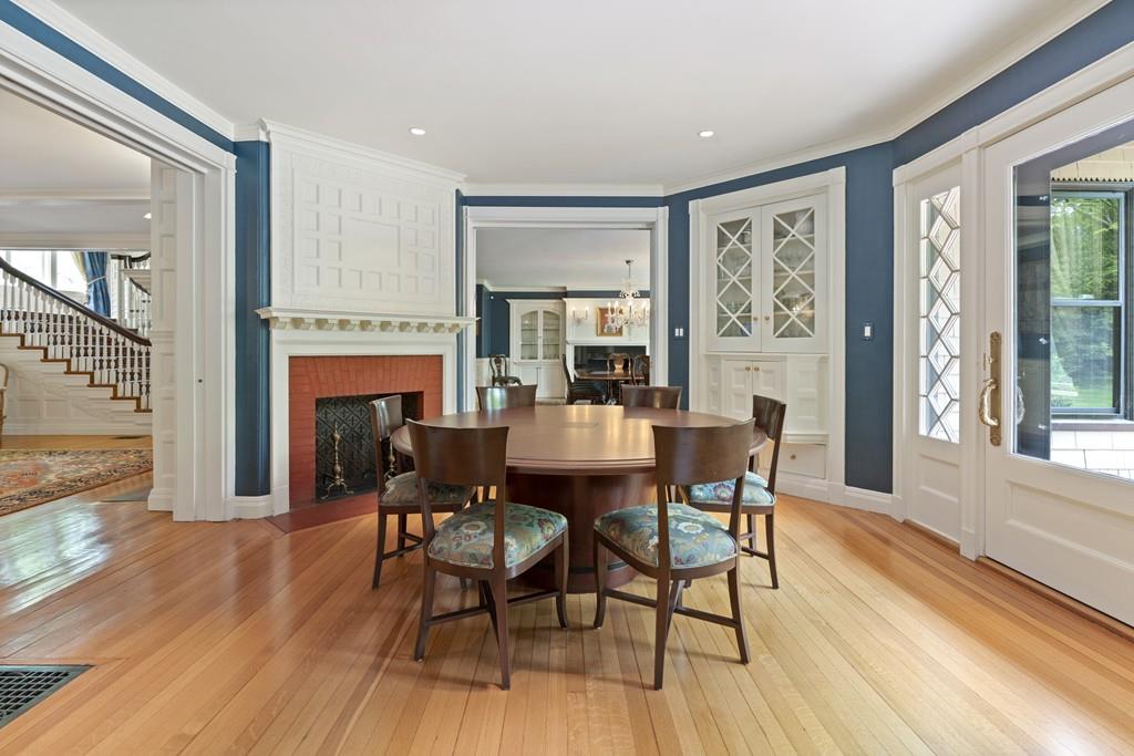 30 Warren Street Brookline, MA 02445 - Photo 15 of 27 a dining room with furniture a fireplace and wooden floor