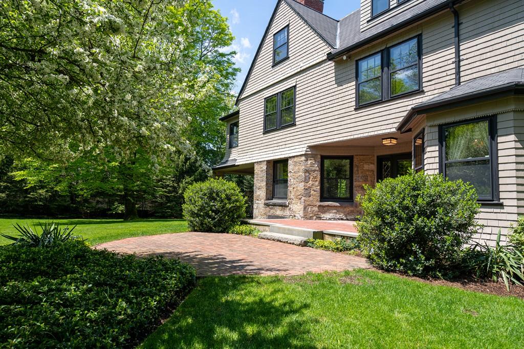 30 Warren Street Brookline, MA 02445 - Photo 7 of 27 a view of a house with a yard plants and large tree