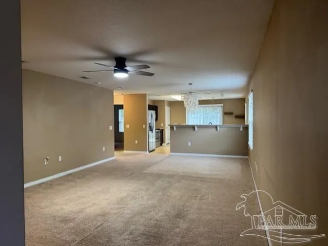 a view of a livingroom with a kitchen and a window