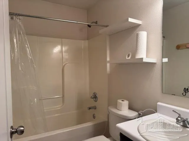 a bathroom with a shower a toilet and a sink