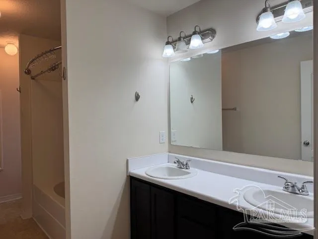 a bathroom with a sink vanity and a mirror