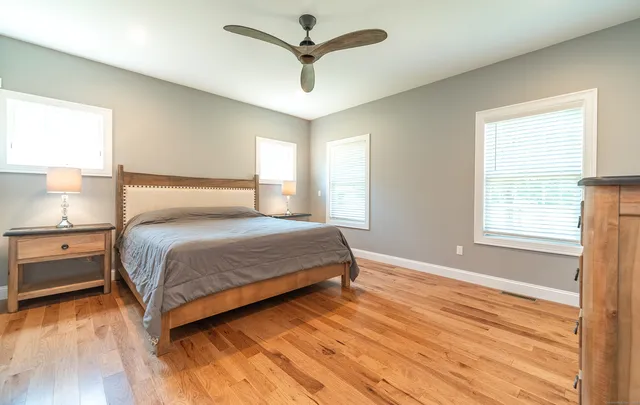 a bedroom with a bed and a window