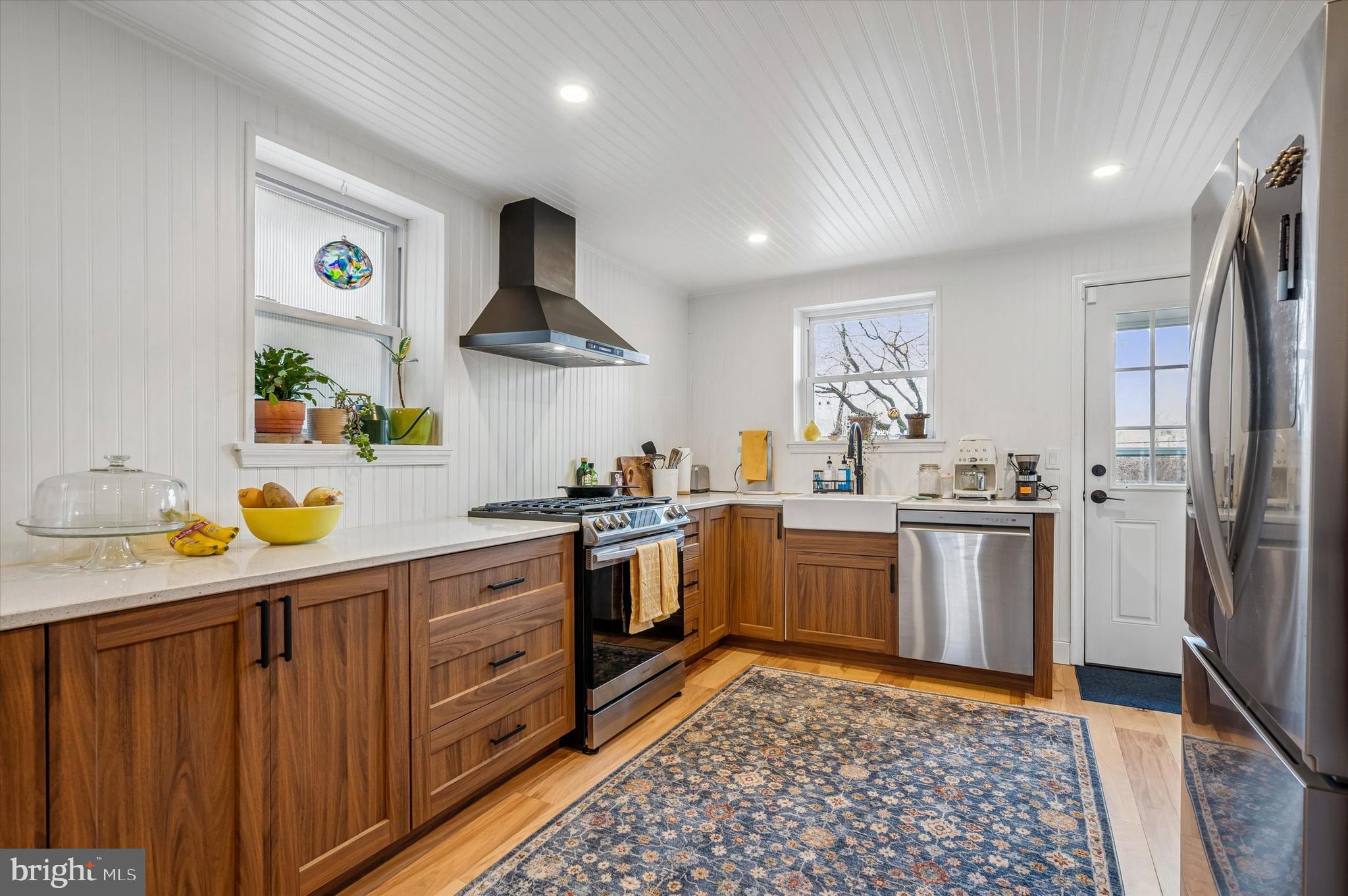 a kitchen with a sink cabinets and stainless steel appliances