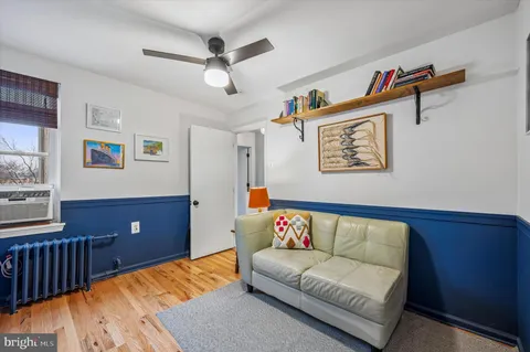 a bedroom with a large bed and a wooden floor
