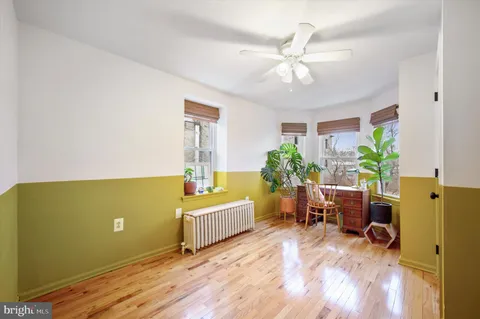 a view of a dining room with furniture and a window