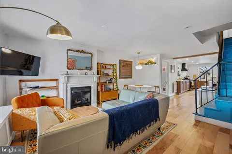 a living room with furniture a flat screen tv and a fireplace