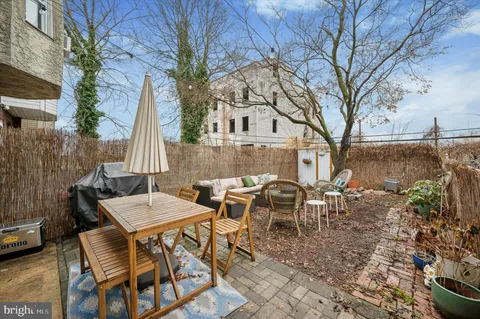a view of a patio with couches table and chairs and potted plants