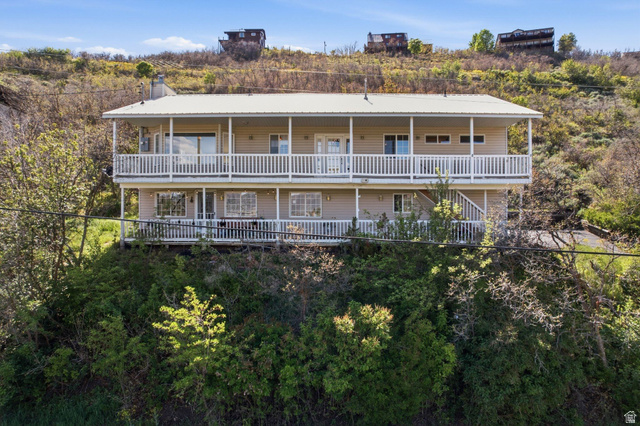 380 Luzern Road Midway, UT 84049 - Photo 4 of 74 Two-story home with a light-toned siding exterior and a white metal roof
