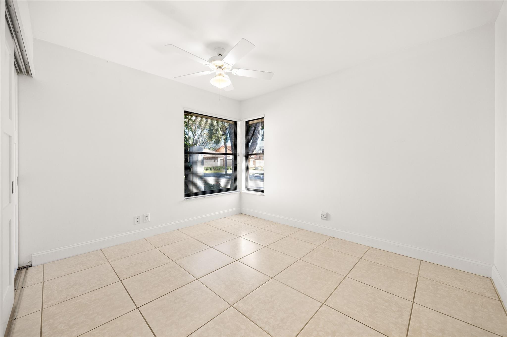6825 Allegre Court Boca Raton, FL 33433 - Photo 13 of 31 an empty room with windows and fan