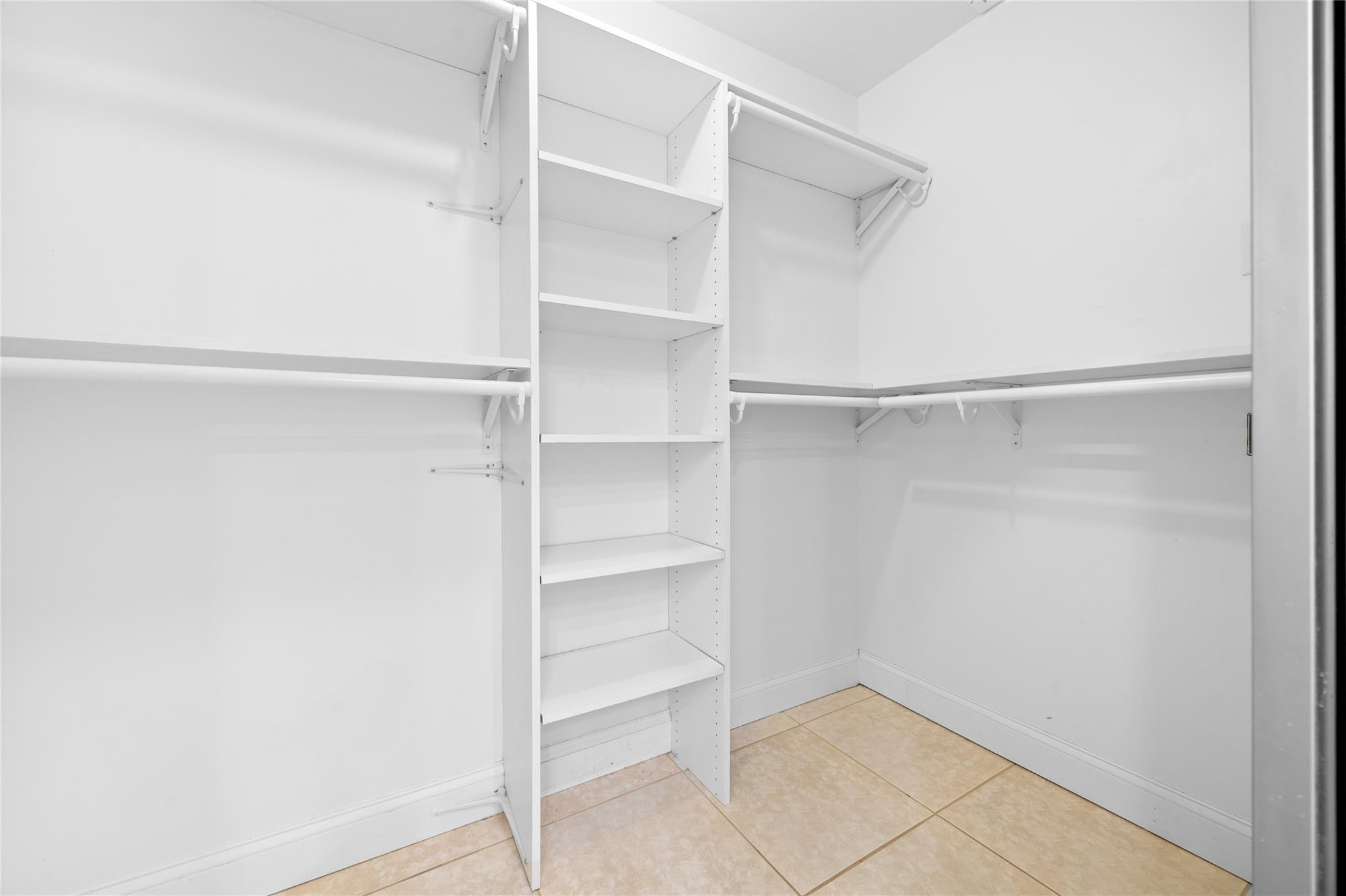 6825 Allegre Court Boca Raton, FL 33433 - Photo 19 of 31 a view of an empty walk in closet