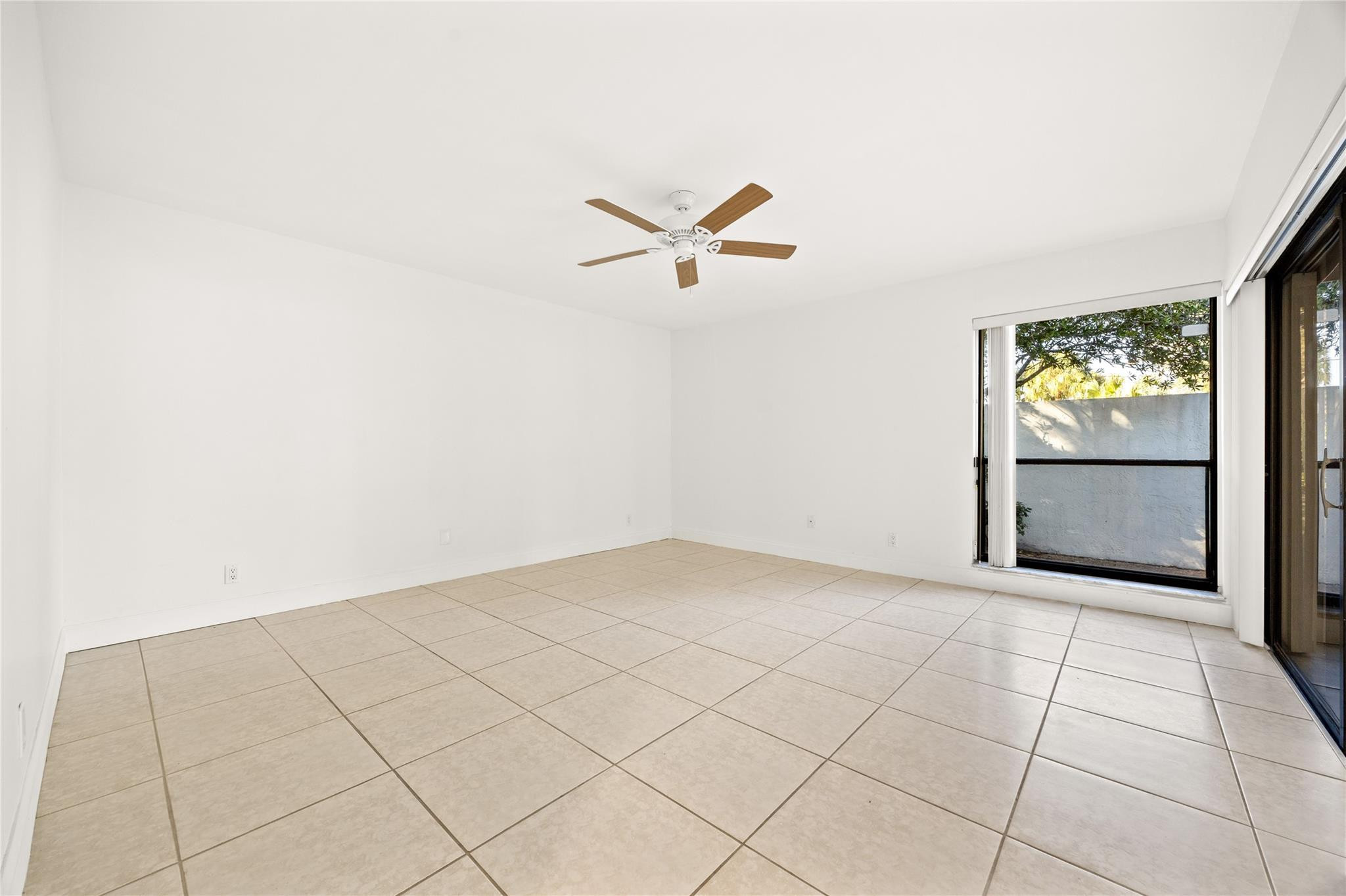6825 Allegre Court Boca Raton, FL 33433 - Photo 20 of 31 an empty room with windows and fan