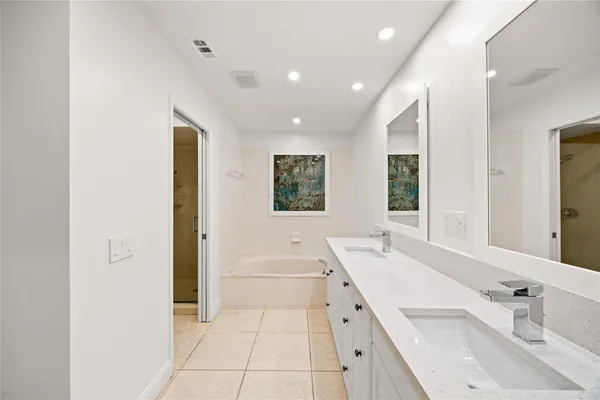 a bathroom with a bathtub sink and mirror