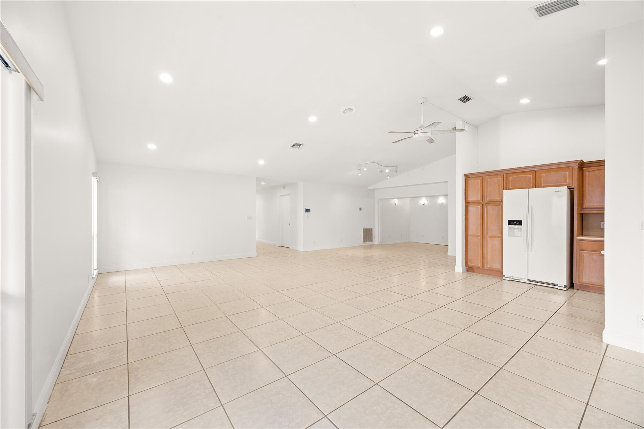 6825 Allegre Court Boca Raton, FL 33433 - Photo 6 of 31 an empty room & kitchen with a hallway to ceiling window
