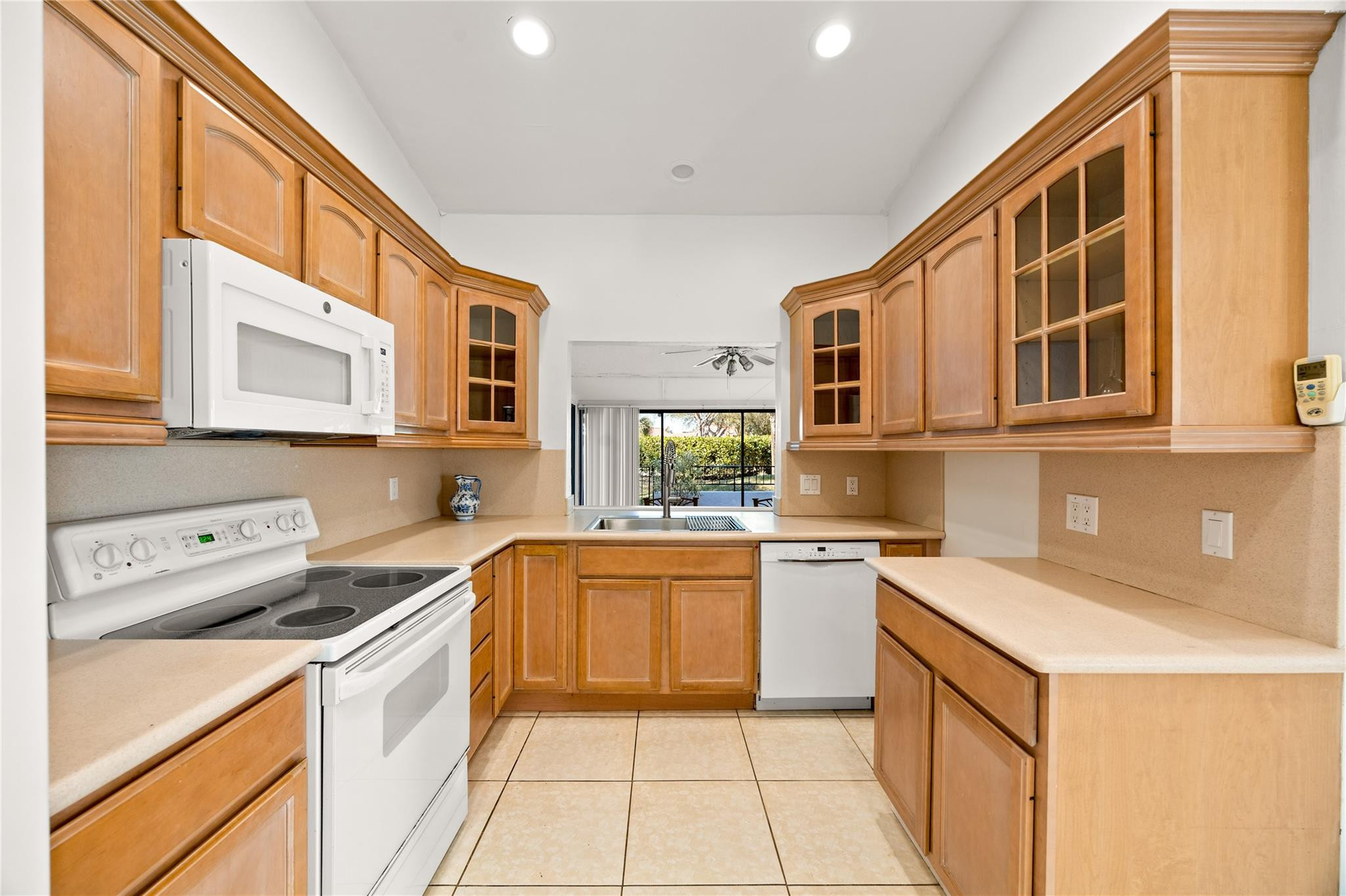 6825 Allegre Court Boca Raton, FL 33433 - Photo 10 of 31 a kitchen with a stove a sink and a refrigerator