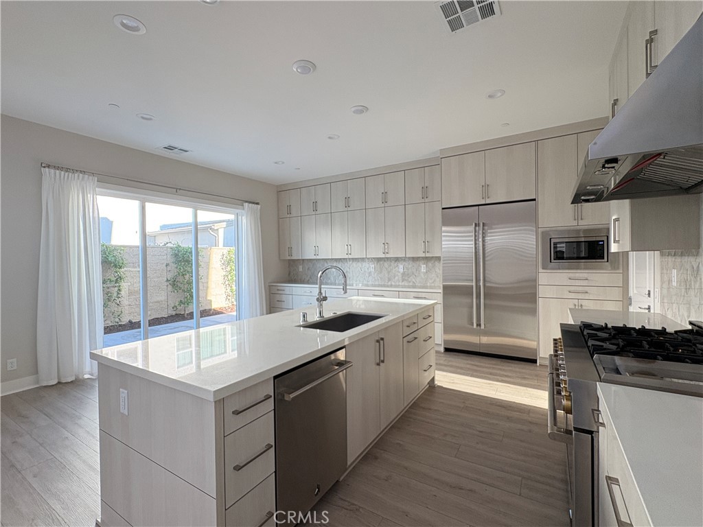 160 Longden Lake Forest, CA 92630 - Photo 12 of 31 a large kitchen with a large window and stainless steel appliances
