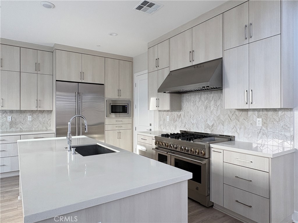 160 Longden Lake Forest, CA 92630 - Photo 13 of 31 a kitchen with granite countertop a sink a stove and cabinets