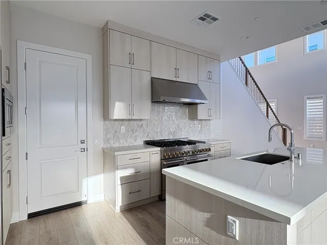 a kitchen with cabinets and a stove