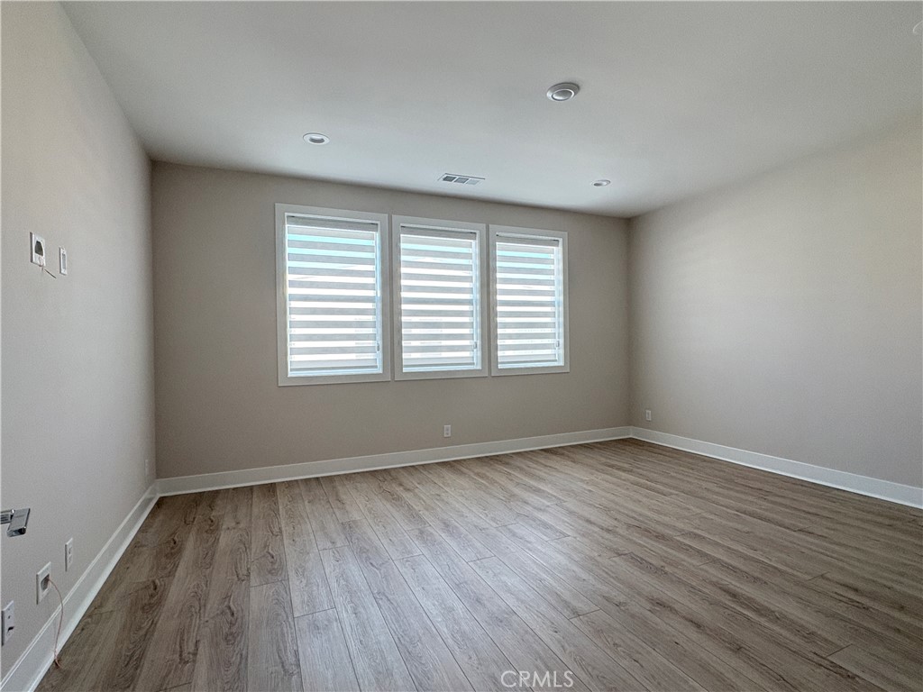 160 Longden Lake Forest, CA 92630 - Photo 18 of 31 a view of an empty room with wooden floor and a window