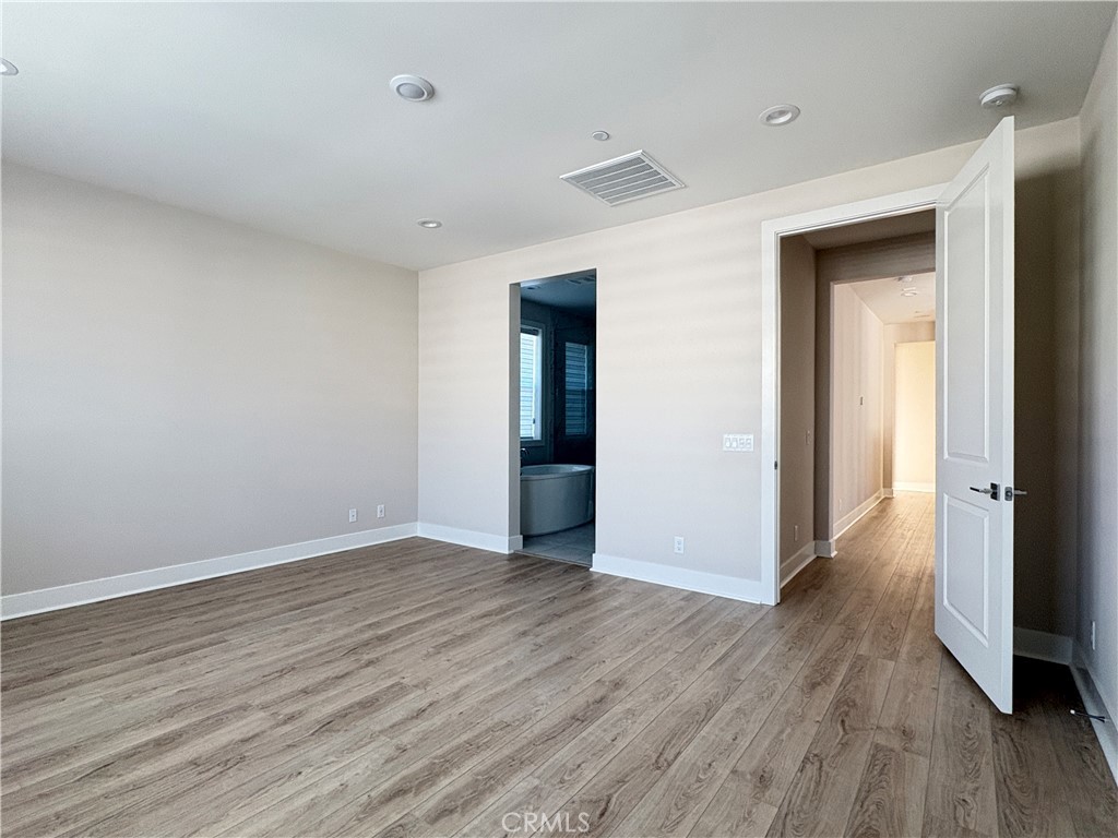 160 Longden Lake Forest, CA 92630 - Photo 19 of 31 a view of an empty room with wooden floor