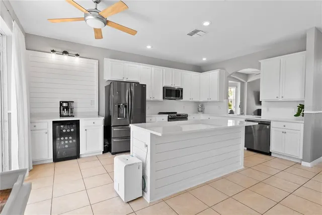 a kitchen with a refrigerator and a stove top oven