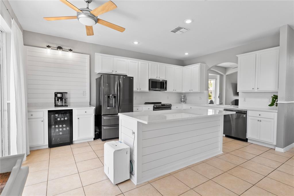 3149 Twisted Oak Loop Kissimmee, FL 34744 - Photo 12 of 52 a kitchen with a refrigerator and a stove top oven
