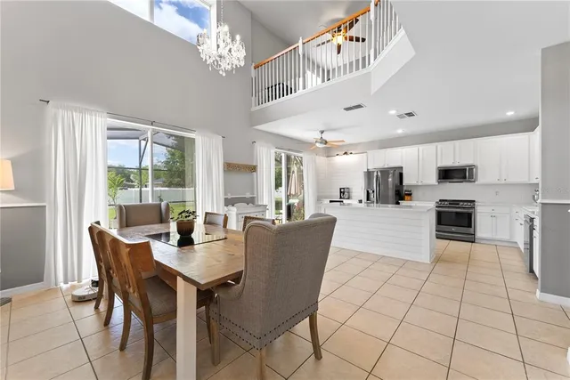a view of kitchen with dining area and windows